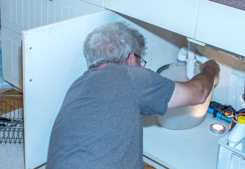 Plumber Fixing a Sink